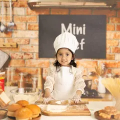 Welcome to the mini chef's kitchen! I love bringing imaginative themes to life, and this little baker, complete with a chef's hat and flour on her hands, makes for an incredibly fun and unique toddler photoshoot.