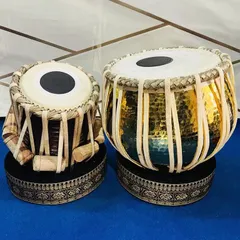 This is our handcrafted brass designer tabla set, featuring a 3kg dagga (left drum) and a D-scale tabla. The hammered pittal finish and professional quality rings make it a stunning instrument for both its sound and appearance.