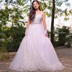 A full view of this sparkling white wedding gown. The voluminous skirt and glittering details make it a perfect choice for a fairytale church ceremony.