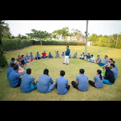 Leading an icebreaker session in a circle. This format is great for helping team members learn about each other in a relaxed, informal outdoor setting.