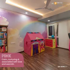 The same whimsical kid's room, showcasing how the pink color scheme creates a calm and loving environment. The open bookshelf encourages a love for reading from a young age.