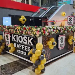 This view shows how the balloon clusters frame the kiosk's logo and service area. My goal is to enhance your branding, not distract from it, ensuring the decoration supports your business's look and feel.