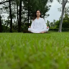 Taking my meditation practice outdoors. Sitting in a simple cross-legged pose on the grass helps me feel grounded and connected to the earth's energy, bringing a sense of profound peace.