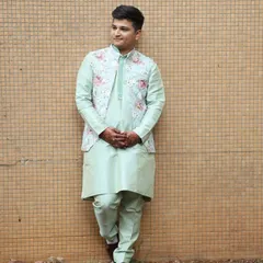 This client is wearing a pista green kurta set with a floral open jacket. It's a comfortable yet stylish choice for a Mehendi or other pre-wedding celebration.