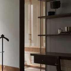 An identical shot of the desk and cane wardrobe, highlighting the clean lines and beautiful craftsmanship of the custom furniture.
