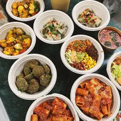 A variety of our dishes packed and ready for delivery. This order shows the range of our menu, from Italian pasta and falafel to Indian paneer tikka and burrito bowls.