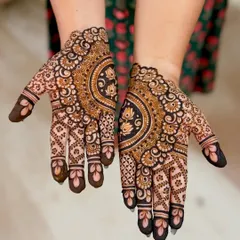 A beautiful semi-circular mandala design on the palm, filled with intricate floral and geometric patterns.