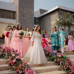 The bride's grand entrance, walking down a staircase lined with flowers with her bridesmaids. This is a key moment that I always ensure to capture from the best angle.