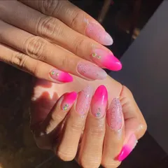 A vibrant pink ombré with a "sugar" glitter top coat and a few scattered rhinestones. It's fun, sparkly, and perfect for summer.