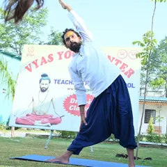 Finding my own balance while teaching. Here I am in Trikonasana during an outdoor class, demonstrating the pose for our students.