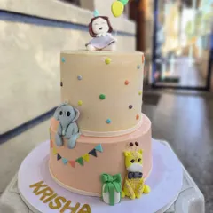 I love bringing imagination to life with cakes like this two-tiered birthday creation. It features adorable, hand-sculpted fondant animals like a baby elephant and giraffe, perfect for a whimsical celebration for your little one.