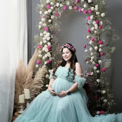 The radiant glow of motherhood deserves to be celebrated. In my Noida studio, I create dreamlike settings like this floral arch, using a stunning off-shoulder tulle gown from my collection to make you feel like the queen you are.