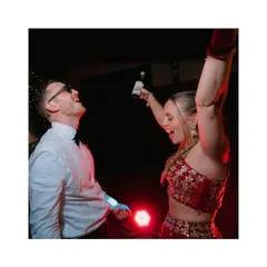 Pure joy on the dance floor. This shot captures the couple letting loose during their reception, a moment of unfiltered happiness and celebration.
