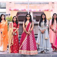 The bride and her squad! This photo captures the bride with her bridesmaids, all looking stylish and happy. It's a great memory of the friendship and support surrounding the bride on her big day.