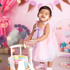 Pure happiness and a face full of frosting. This shot from our candy and ice cream themed cake smash shows the genuine laughter and messy fun that makes these sessions so special.