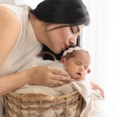 A soft kiss for her sleeping baby. These are the quiet, intimate moments that I strive to capture, preserving the tenderness of early motherhood.