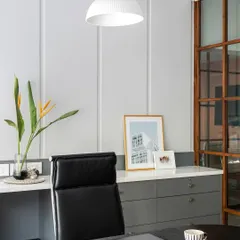 Another view of a private cabin, featuring a grey and white color scheme and a modern pendant light. The large teak wood and glass partitions allow light to flow through the entire office.