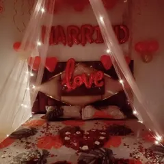 A classic romantic room decoration for a wedding night or anniversary. I used "MARRIED" and "love" foil balloons, a canopy over the bed with fairy lights, and scattered rose petals to create a sweet and intimate surprise.