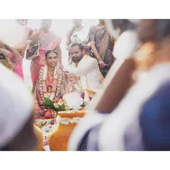 A candid shot from a different perspective, capturing the wedding ceremony through the crowd. This angle makes you feel like you are right there, witnessing the moment unfold.
