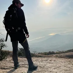 Taking in the vast, misty morning view from the top of Savandurga. This is a popular spot for sunrise treks near Bangalore.