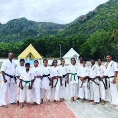 A group of our black and green belt students during a special Black Belt Camp, set against a beautiful natural backdrop.
