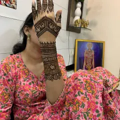 A client showing off her beautiful elephant motif mehndi at home. It's a pleasure to bring my art to your personal space, making your celebrations convenient and memorable.