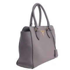 A side-angle shot of a grey Prada handbag, highlighting its shape, structure, and leather texture for a luxury resale or e-commerce site.