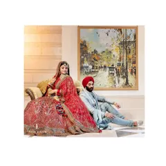 A full-length portrait of the Sikh couple, posed like royalty in an elegant room, her red lehenga a stunning centerpiece.