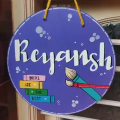 This nameplate was designed for Reyansh, a young boy who loves both art and books. I incorporated a stack of colorful books and paintbrushes into the design to reflect his hobbies, making it a truly personal piece for his room.