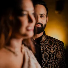 An artistic engagement portrait focusing on his loving gaze. With her slightly out of focus in the foreground, this shot creates a sense of depth and anticipation.
