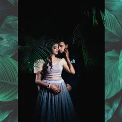 A dramatic and moody portrait of a couple, using shadows and natural elements like palm leaves to create an artistic and intimate feel. This highlights our cinematic editing style.