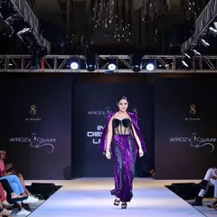 A look from one of my runway collections, this purple two-piece features a sequined corset top and a matching velvet pant set with an attached jacket. This design showcases my love for mixing textures and creating head-turning evening wear.
