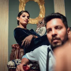 A powerful, fashion-inspired pose from a vintage-themed shoot. The unique angle and the couple's confident expressions give this portrait a high-fashion, editorial feel.