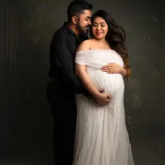 A classic, elegant couple's portrait. The way he holds her, and the peaceful expression on her face, speaks volumes about their shared journey.