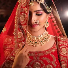 A series of portraits showcasing a model in a heavily embroidered red bridal lehenga. I focused on capturing the intricate details of the outfit and the flawless bridal makeup, presenting a look of regal elegance.