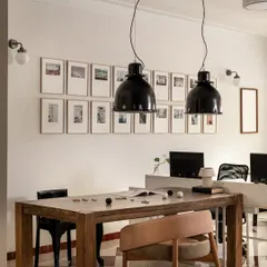 A look inside our own commercial studio in Mumbai, where we bring our ideas to life. This space features a large wooden collaboration table under dramatic black pendant lights, with a gallery wall of our inspirations. It’s designed to be a functional workspace that feels warm, human, and encourages creativity.