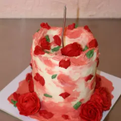 Because love deserves to be celebrated in every bite. A close-up of our rustic red rose cake, ready for a birthday celebration.