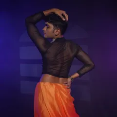 A shot from the back, showing the complete look including the sheer top. Even the back and shoulders are considered for a full performance look.