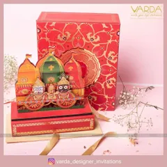 This spectacular wedding invitation box is themed around the Jagannath Rath Yatra. The vibrant, multi-layered pop-up of the deities on their chariots creates a festive and deeply spiritual invitation that is sure to awe your guests.
