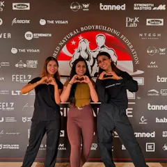 Sharing a moment with my clients before they hit the WNBF Singapore stage. Building a strong, supportive team environment is a core part of my coaching philosophy.