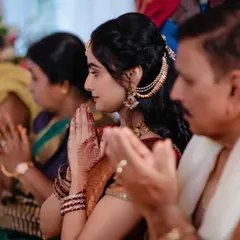 A candid shot of a bride-to-be and her family in prayer during the engagement ceremony. We capture the spiritual and familial aspects of the day.