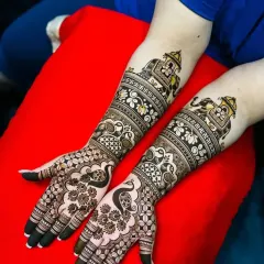 This design is a celebration of traditional motifs, with peacocks, elephants, and auspicious symbols like the swastika.