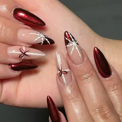 All wrapped up for the holidays. This festive set combines a stunning red chrome with accent nails featuring hand-painted bows and stars.