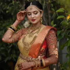 A close-up of Taanya, her bridal glow enhanced by the rich colors of her traditional attire.