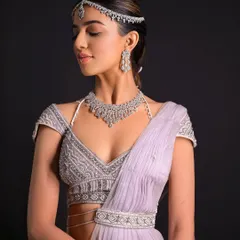 A portrait of the bride, showing the elegance of the simple hairstyle paired with a glamorous outfit.