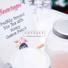A sign for our freshly brewed iced tea at a recent event. We create bespoke menus that infuse global flavors, and our beverage stations are no exception, offering refreshing options to complement the food.