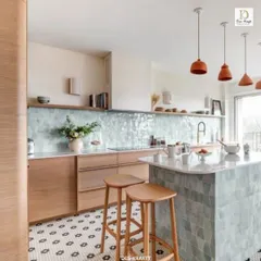 We believe a kitchen should be both beautiful and highly functional. This modern kitchen design features a stunning pastel blue tile backsplash, a versatile island with bar seating, and natural wood cabinetry, creating a bright and airy atmosphere for cooking and gathering.
