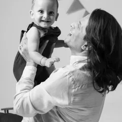 The pure joy of a father lifting his baby high. This black and white shot freezes a perfect moment of laughter and connection.