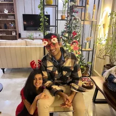 A happy client couple celebrating Christmas in their newly designed living room.