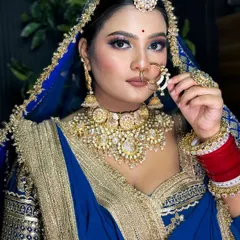 I love creating unique looks that honor tradition. Here is a stunning Rajputi bridal look, featuring a bold blue lehenga with traditional gold jewelry and makeup that highlights the bride's regal elegance.